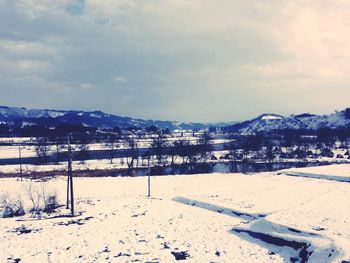 Scenic view of snow covered mountains against sky