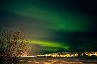 Scenic view of illuminated landscape against sky at night