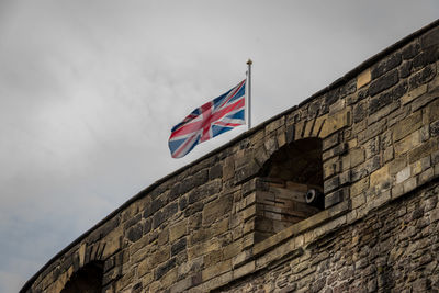 Low angle view of flag against building