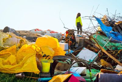Woman walking on illegal garbage dump