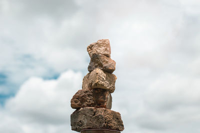 Low angle view of stone stack against sky