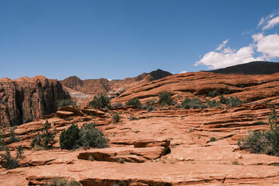 Scenic view of mountains against blue sky