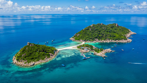 Aerial view of island against sky during sunny day