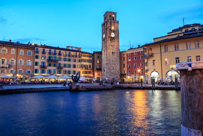 Bridge over river against buildings in city