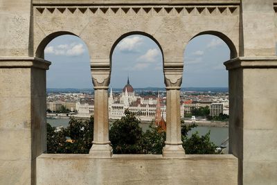 Hungarian parliament building seen through arch window