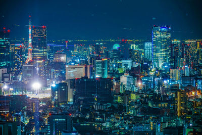 Illuminated cityscape against sky at night