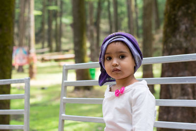 Portrait of cute girl standing on land