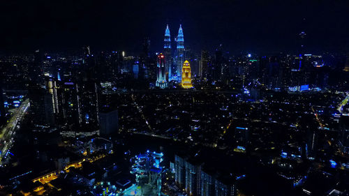 High angle view of city lit up at night