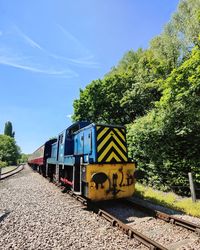 Train on railroad track against sky