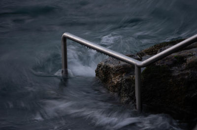 Sea seen through metal fence
