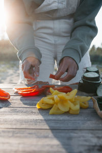Midsection of man preparing food on table