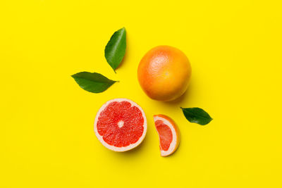 Directly above shot of fruits on yellow background