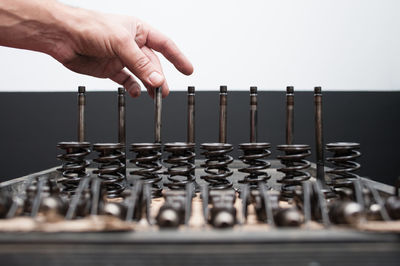 Cropped hand of worker with machine part