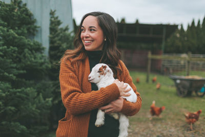 Portrait of young woman holding a horse