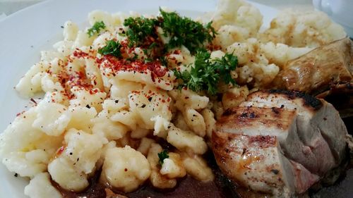 Close-up of meat with mashed potatoes in plate