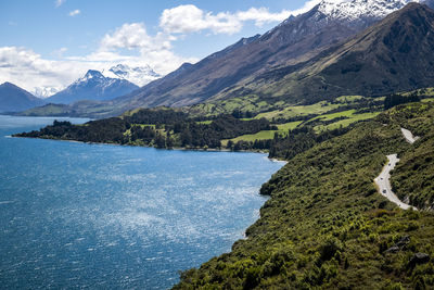 Scenic farms, snowy mountains, road and lake landscape in new zealand