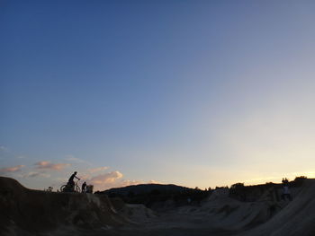 Silhouette of landscape against clear sky