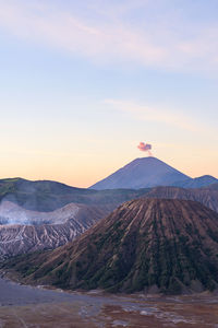 Scenic view of crater and mountain with smoke against sky at sunrise, bromo volcano, java, indonesia
