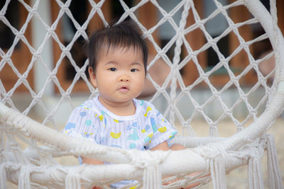 Portrait of cute boy in fence