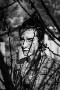 Portrait of young man seen through plants