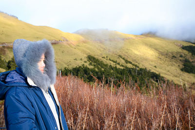 Rear view of man looking at field