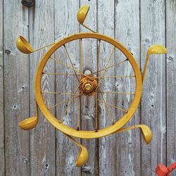 Close-up of yellow decorations hanging on wood