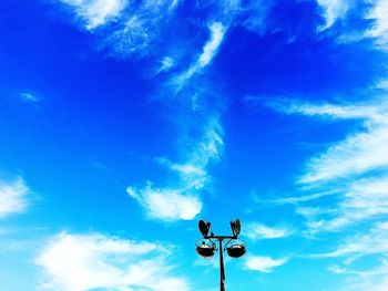 Low angle view of street light against blue sky