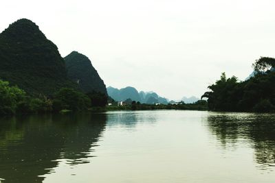 Scenic view of lake and mountains against sky