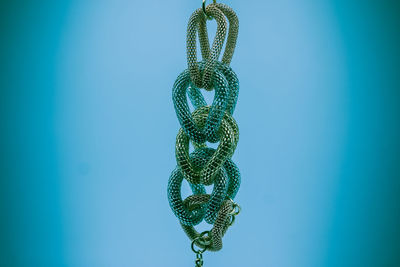 Close-up of decoration hanging against blue background