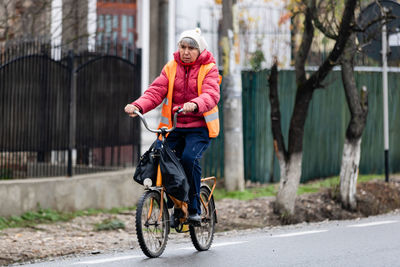 Portrait of woman riding bicycle on road