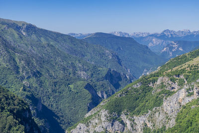 Scenic view of mountains against clear blue sky