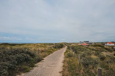 Dirt road along countryside landscape