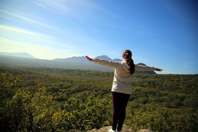 Full length of man standing on landscape against sky