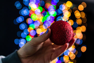 Close-up of hand holding multi colored lights