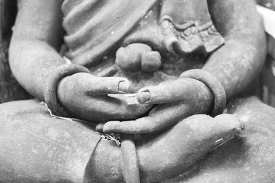 Close-up of human hand holding statue