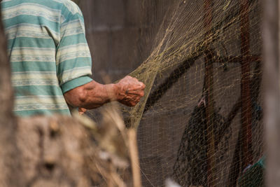 Midsection of farmer holding net