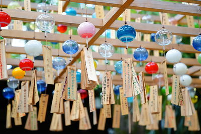 Low angle view of multi colored decorations hanging on wood