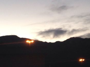 Scenic view of silhouette mountains against sky at sunset