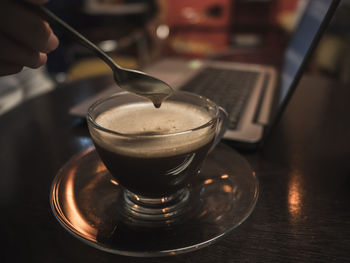 Close-up of coffee cup on table.