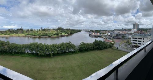 Panoramic view of river amidst city against sky