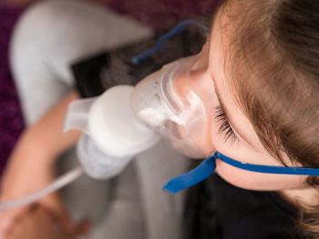 High angle view of girl drinking bottle