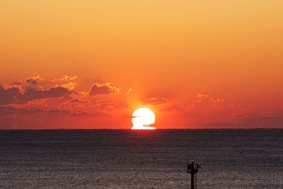 Scenic view of sea against orange sky