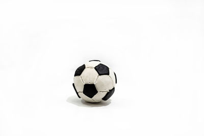 Close-up of light bulb on soccer ball against white background