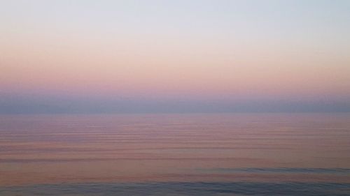 Scenic view of sea against sky at sunset