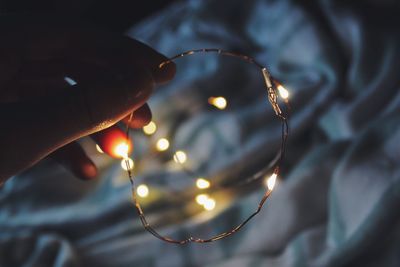 Close-up of hand holding illuminated lights