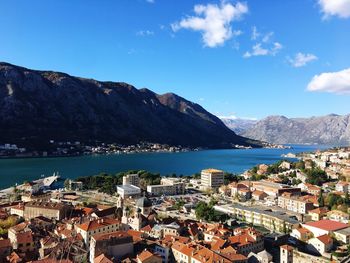 Town by sea against blue sky