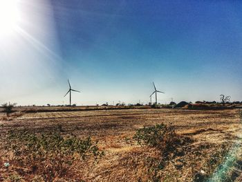 Wind turbines in farm against clear sky