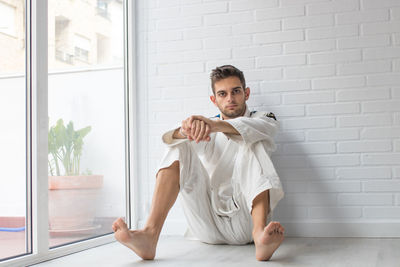 Portrait of young man sitting at home