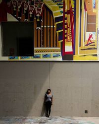 Full length of woman standing in front of building