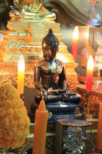 Statue of lit candles in temple